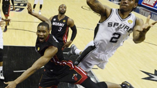 San Antonio Spurs' Kawhi Leonard (2) shoots as Miami Heat's Chris Bosh (1) defends during the second half at Game 5 of the NBA Finals basketball series, Sunday, June 16, 2013, in San Antonio. The Spurs won 114-104. (AP Photo/Brendan Maloney, Pool)
