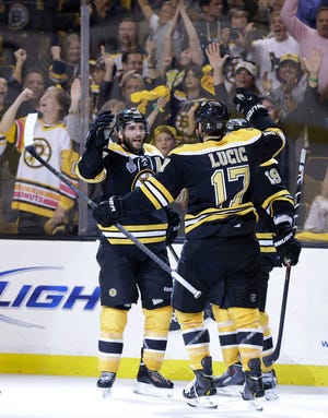 Boston's Patrice Bergeron (left) celebrates his goal with Milan Lucic (17) and Tyler Seguin during the second period.