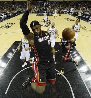 Miami Heat's LeBron James (6) dunks against the San Antonio Spurs during the first half at Game 5 of the NBA Finals basketball series, Sunday, June 16, 2013, in San Antonio. (AP Photo/Brendan Maloney)