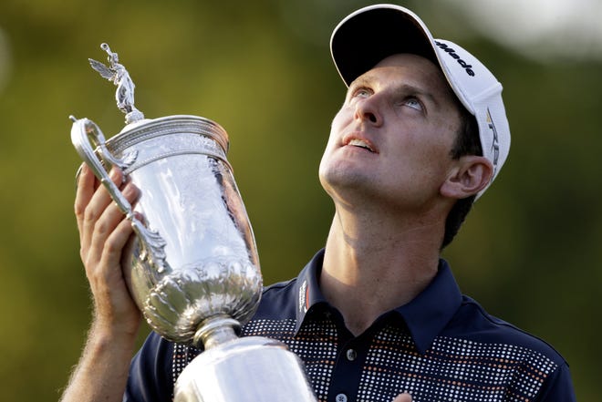 Justin Rose of England poses with the trophy after winning the U.S. Open golf tournament at Merion Golf Club, Sunday, June 16, 2013, in Ardmore, Pa.