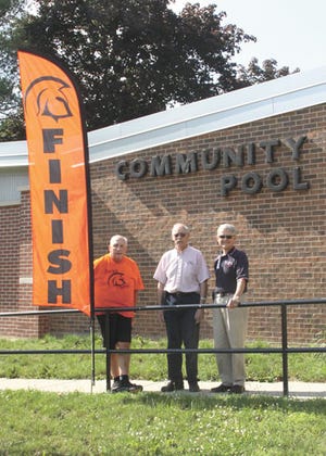 Tom Shumaker, far left, has had help from both Phil Pattengale and Jim Cook in organizing the Trojan Triathlon, which will take place Saturday at the community pool.