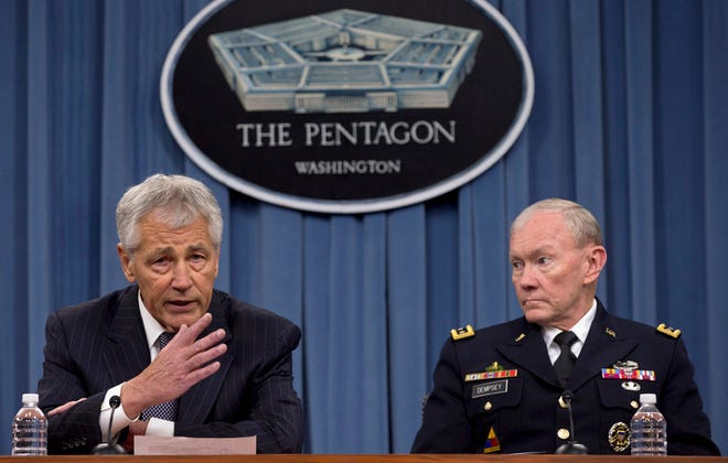 FILE - In this May 17, 2013 file photo Defense Secretary Chuck Hagel, left, and Chairman of the Joint Chiefs of Staff, Gen. Martin Dempsey take turns talking to media during a news conference at the Pentagon. Women may be able to begin training as Army Rangers by mid-2015, and as Navy SEALs a year later under broad plans Defense Secretary Chuck Hagel is approving that would slowly bring women into thousands of combat jobs, including those in the country's elite special operations forces, according to details of the plans submitted to Hagel that were obtained by The Associated Press. (AP Photo/Carolyn Kaster, File)