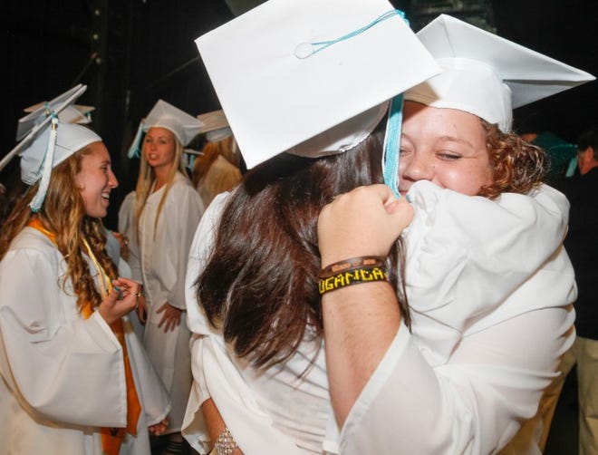 Bucks County Technical High School's Class of 2013 graduated during a commencement ceremony at Sun National Bank Center in Trenton New Jersey. Jessica Quintana, a commercial art program graduate, gets a big hug from Kylie Corbett, right, who graduated from the Allied Health program as they celebrated their accomplishment.