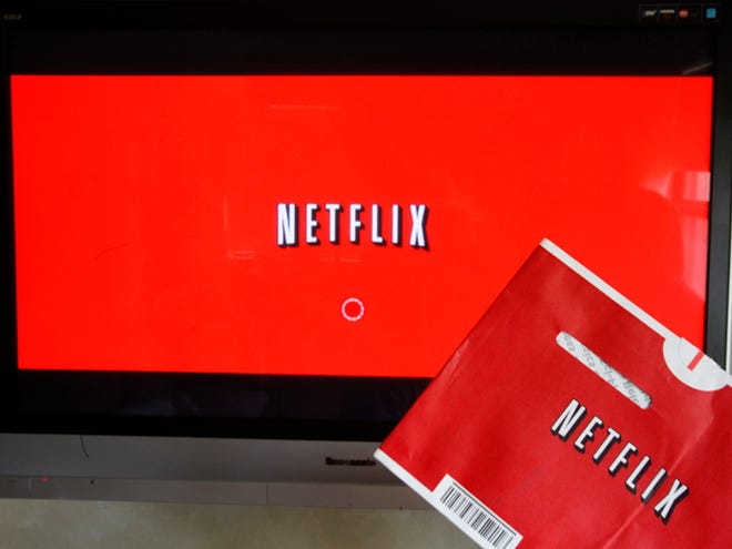 A Netflix DVD envelope and Netflix on-screen television menu are shown on Oct. 1, 2011, in Surfside, Fla. Netflix is going to start running original television series from Dreamworks Animation, the company announced Monday.