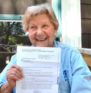 Lillian Broide of Braintree holds a letter from Social Security about changes in her online account.