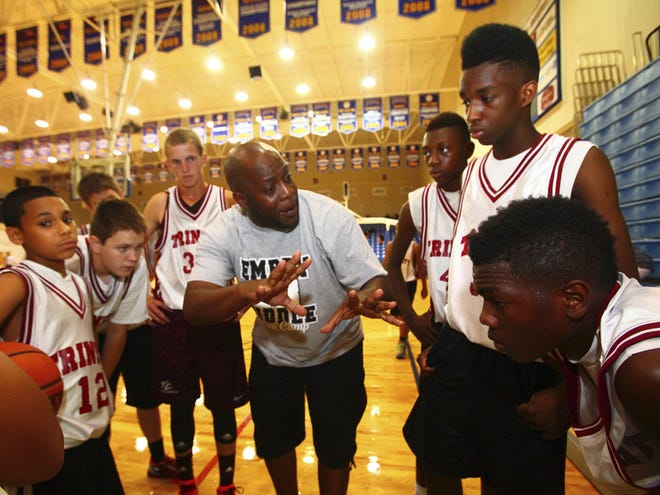 New Trinity Christian basketball coach Ray Gaines gives his players some tips during a basketball camp at Embry- Riddle Aeronautical University in Daytona Beach on Wednesday.