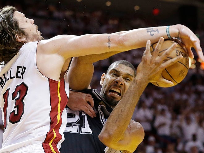 San Antonio Spurs power forward Tim Duncan (21) works as Miami Heat shooting guard Mike Miller (13) defends during the second half of Game 6 of the NBA Finals basketball game on Tuesday in Miami.