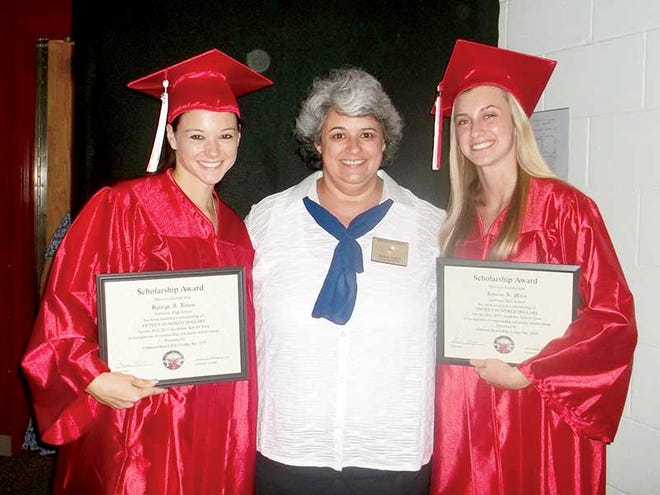 Lyleigh Rojas, left, and Jessica Marx, right, receive $1,500 scholarships from Elks Exalted Ruler Jackie Curtis, center.