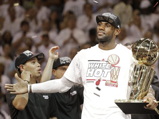 The Miami Heat's LeBron James holds the Larry O'Brien NBA Championship Trophy after Game 7 of the NBA Finals against the San Antonio Spurs on Thursday in Miami.
