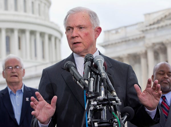 Sen. Jeff Sessions, R-Ala., center, speaks at a news conference hosted by the Tea Party Patriots to oppose the Senate immigration reform bill, Thursday, June 20, 2013, on Capitol Hill in Washington. Behind him are Hans Marsen, left, an immigrant from England, and Niger Innis with TheTeaParty.Net. White House-backed immigration legislation gained momentum in the Senate on Thursday as lawmakers closed in on a bipartisan compromise to spend tens of billions of dollars stiffening border security without delaying legalization for millions living in the country unlawfully. (Jacquelyn Martin | Associated Press)