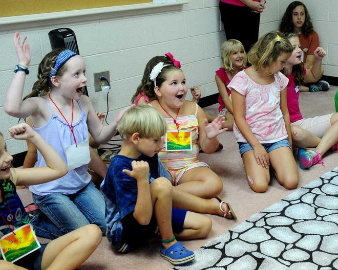 A group of children listens to the story of Zacchaeus during a class for Vacation Bible School at The Hill Baptist Church.