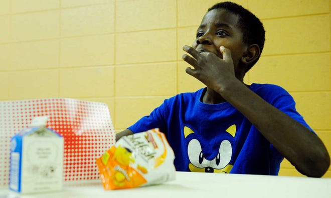 Wendarius Harris, 11, eats Goldfish crackers during lunch at the May Park Community Center, one of 63 locations in Richmond County serving meals as part of a summer feeding program.