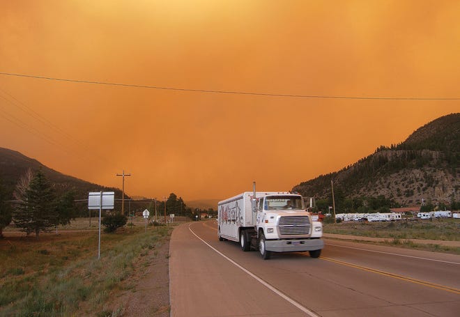 Smoke from the West Fork Fire surrounds drivers on Colorado 149 near South Fork, Colo. Thursday, June 20, 2013. The highway was later closed and mandatory evacuation orders issued for the nearby town of South Fork. (AP Photo/The Pueblo Chieftain, Matt Hildner)