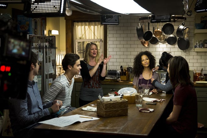 The cast of "The Fosters," where parents, played by Teri Polo, hands in air, and Sherri Saum, seated in purple stripes, are raising a biological son and several adopted children, seen on the set of their ABC drama, June 10, 2013. (Jay L. Clendenin/Los Angeles Times/MCT) ORG XMIT: 1140103
