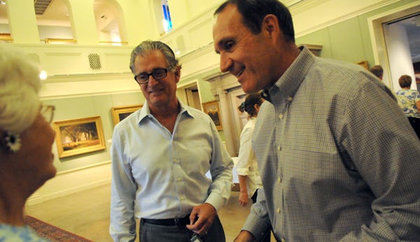 Former NFL Director of Officiating Mike Pereira, left, and NFL referee Peter Morelli greet people before their talk Thursday night at The Haggin Museum's exhibit, “Pro Football and the American Spirit: The NFL and the U.S. Armed Forces.”
