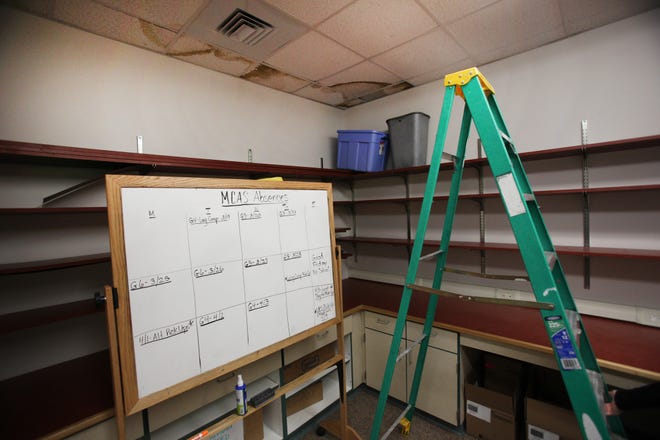 The MCAS room at Hobomock Elementary School has buckets to catch leaks from its damaged ceiling tiles.