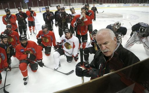 Chicago Blackhawks head coach Joel Quenneville, right, diagrams a drill during an NHL hockey practice Friday, June 21, 2013 in Chicago. The Blackhawks will host the Boston Bruins in Game 5 of the Stanley Cup Final series Saturday.