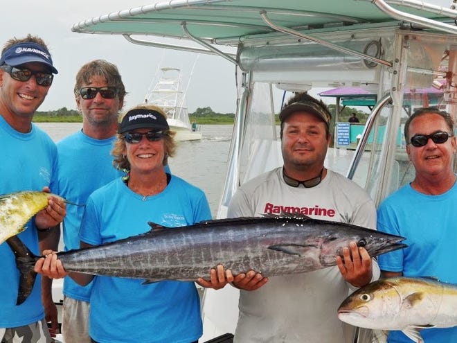 Shane Murray, Rob Evans, Pat Hughes, Eric Sheridan and Barry Hughes hold the wahoo Saturday they hope will take them to the King of the Inlet championship.