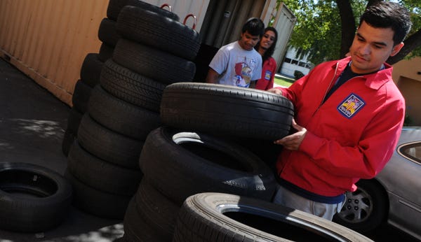 Bear Creek High student David Ramirez checks the used tires Friday at America's Tire on Pacific Avenue in Stockton.