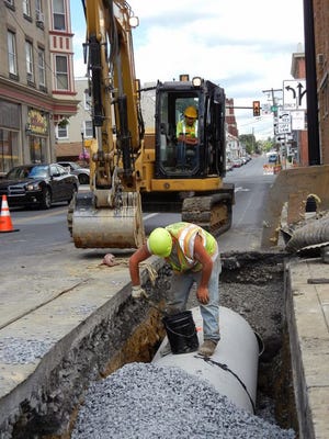 Crews with David H. Martin Excavating continue stormwater management upgrades along Waynesboro’s South Potomac Street near the intersection of Gay and Main streets Wednesday.