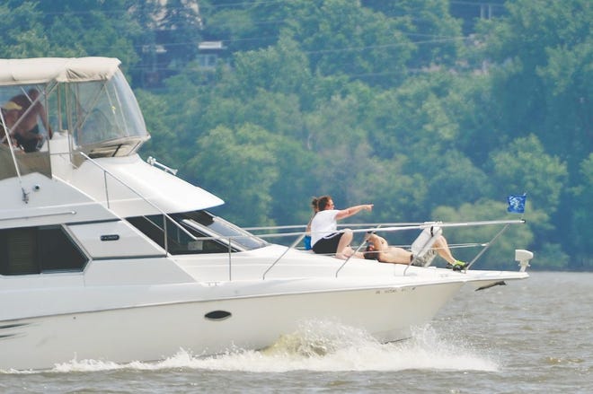 Boaters enjoy the warm weather on the Illinois River on Sunday near Detweiller Marina.