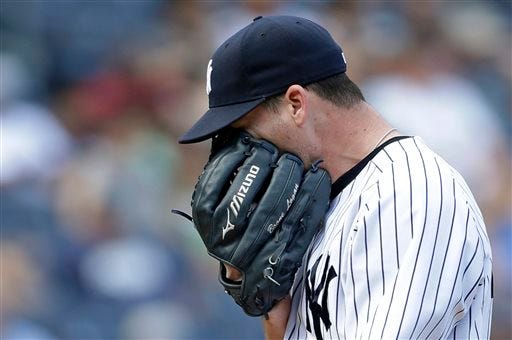 Yankees relief pitcher Boone Logan reacts after allowing a seventh-inning two-run single to Tampa Bay Rays' James Loney on Sunday, June 23, 2013, in New York.