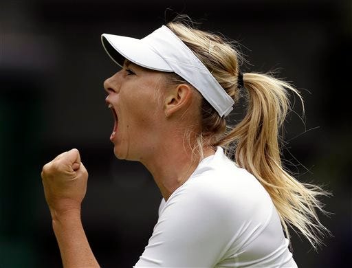 Maria Sharapova of Russia reacts after winning the first set against Kristina Mladenovic of France during their Women's first round singles match at the All England Lawn Tennis Championships in Wimbledon, London, Monday, June 24, 2013.
