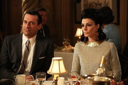 This TV publicity image released by AMC shows Jon Hamm as Don Draper, left, and Jessica Pare as Megan Draper in a scene from "Mad Men." The season finale airs Sunday, June 23, on AMC.