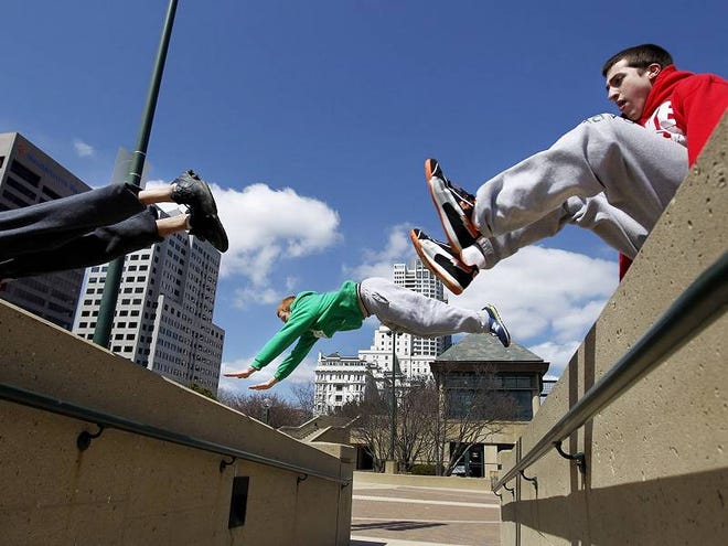 From left, Aaron Evans, Michael Hartwig and Aaron Burns, sail over cement walls at O’Donnell Park in Milwaukee.