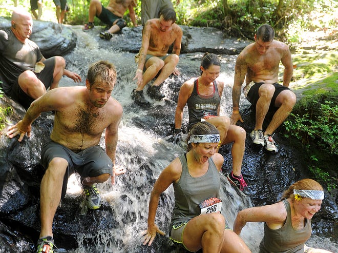 Barbarian participants slide down a water portion of the course during the Barbarian Challenge at Noccalula Falls in Gadsden, Alabama. June 15, 2013.