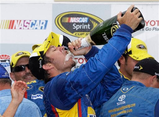Martin Truex Jr. celebrates after winning the NASCAR Sprint Cup series auto race on Sunday, June 23, 2013, in Sonoma, Calif.