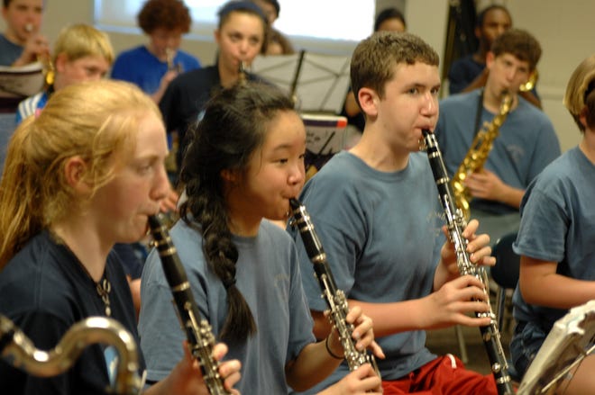 Gates School musicians Maeve Chapman, Emma Dwyer and Connor Ahern concentrate during the band’s gold medal performance at the Great East Music Festival, held last month at Canobie Lake. Not to be outdone, the Gates chorus also brought home the gold! KEVIN MORRILL PHOTOGRAPHY