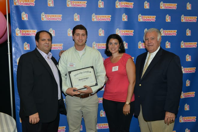 Dunkin’ Donuts franchisees Joe Carvalho (far left) and Michelle Motta-Deleon (second from right), along with Manchester Mayor Ted Gatsas (far right) presented Strafford resident Mark Hodges with a $5,000 college scholarship.