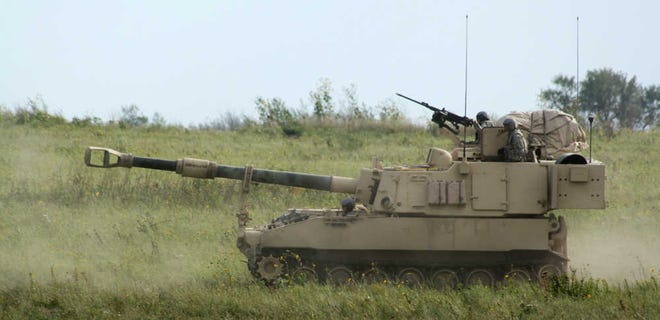 FILE - In this Sept. 12, 2012, file photo an Army Paladin self-propelled howitzer and its crew advances during a training exercise at Fort Riley, Kan. The Army said Tuesday, June 25, 2013, that it would eliminate one infantry brigade at Fort Riley as the military reduces its overall number of soldiers by September 2017. (AP Photo/John Milburn, File)