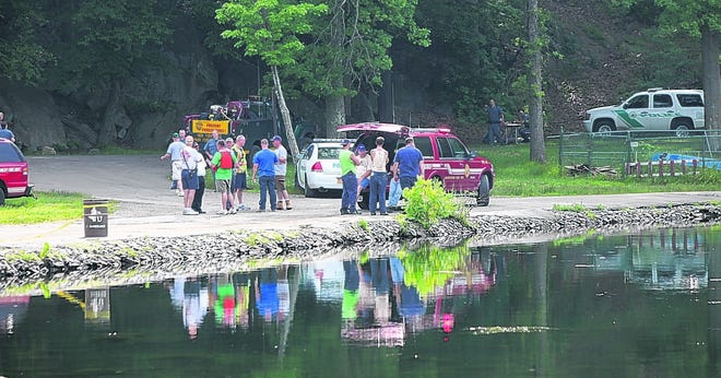 Emergency personnel gather at the edge of Hessian Lake in Bear Mountain State Park after recovering the body of a boy, 16, who drowned there Monday.