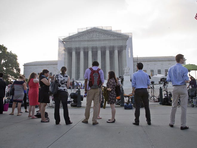 People waiting outside the Supreme Court in Washington as key decisions are expected to be announced on Monday. The Supreme Court said Tuesday that a key provision of the landmark Voting Rights Act cannot be enforced until Congress comes up with a new way of determining which states and localities require close federal monitoring of elections.