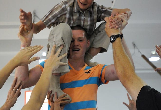 Michael Duffy of Levittown balances Dominick Peake of Yardley on his shoulders during a team-building activity for the Lower Bucks County Chamber of Commerce's youth leadership program at Bucks County Technical High School on Monday afternoon.
