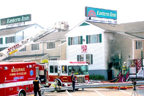 Firefighters at the scene of a three-alarm fire at the Eastern Inn in Buzzards Bay on Tuesday.