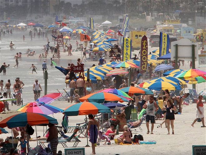 People jam onto Daytona Beach to soak up the sun or hit the surf on a hot Wednesday, June 26, 2013.