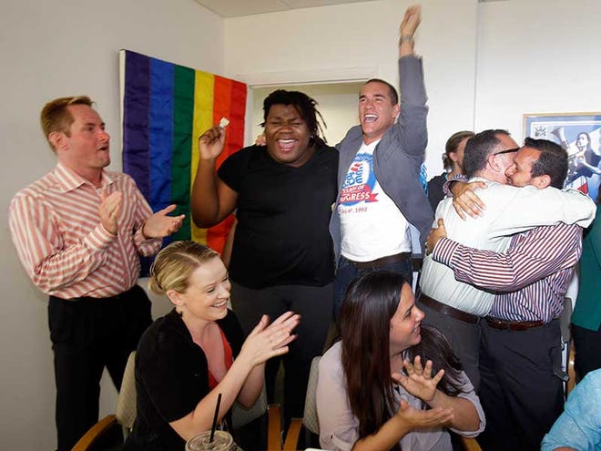Attendees at a watch party in Miami celebrate after the U.S. Supreme Court's ruling on gay marriage in California Wednesday June 26 2013. The justices issued two 5-4 rulings in their final session of the term. One decision wiped away part of a federal anti-gay marriage law that has kept legally married same-sex couples from receiving tax health and pension benefits. The other was a technical legal ruling that said nothing at all about same-sex marriage but left in place a trial court's declaration that California's Proposition 8 is unconstitutional.