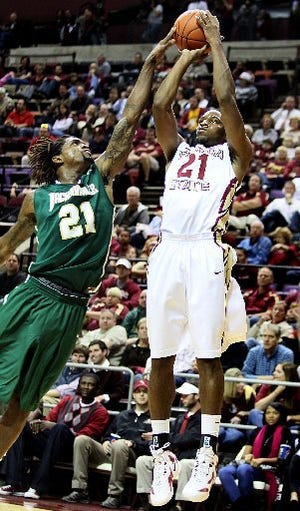 Delwan Graham, left, blocks Michael Snaer's shot attempt as Florida State hosts in state foe Jacksonville University for their first game of the 2011-2012 season.