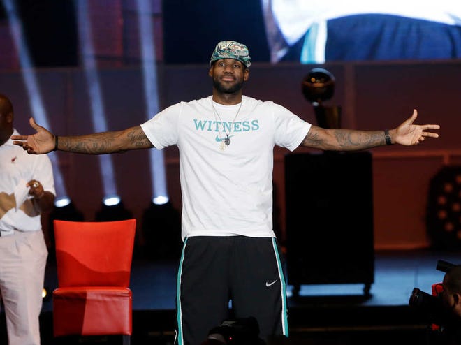 Miami Heat forward LeBron James reacts as he is introduced Monday during a celebration at the American Airlines Arena in Miami.