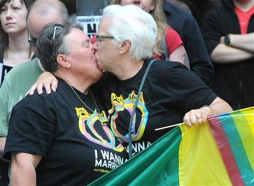 Debbie Diedrich, and Nancy Holston, partners for 33 years, kiss after the U.S. Supreme Court struck down the Defense of Marriage act Wednesday, June 26, 2013 in Pittsburgh. The justices issued two 5-4 rulings in their final session of the term. One decision wiped away part of a federal anti-gay marriage law that has kept legally married same-sex couples from receiving tax, health and pension benefits. The other was a technical legal ruling that said nothing at all about same-sex marriage, but left in place a trial court's declaration that California's Proposition 8 is unconstitutional. (AP Photo/Pittsburgh Post-Gazette, Bob Donaldson) MAGS OUT; NO SALES; MONESSEN OUT; KITTANNING OUT; CONNELLSVILLE OUT; GREENSBURG OUT; TARENTUM OUT; NORTH HILLS NEWS RECORD OUT; BUTLER OUT