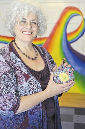 Cindy Turner-Maffei holds a fabric breast model at the Healthy Children Project’s Center for Breastfeeding.