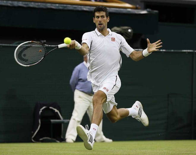 Novak Djokovic returns a shot to Bobby Reynolds during their match at Wimbledon in London on Thursday. Djokovic ousted the 156th-ranked Reynolds 7-6 (2), 6-3, 6-1.  Kirsty Wigglesworth Associated Press