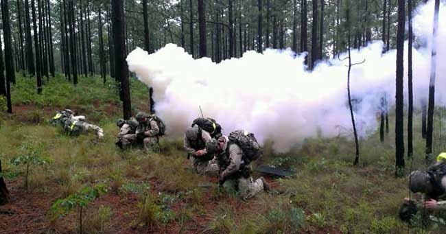 Paratroopers assigned to 1st Squadron, 73rd Airborne Cavalry Regiment, 2nd Brigade Combat Team, 82nd Airborne Division react to a simulated gas attack June 7, during their annual Spur Ride. Soldiers who successfully complete the Spur Ride are awarded the coveted Silver Spurs, a symbol of an expert Soldier and cavalryman.