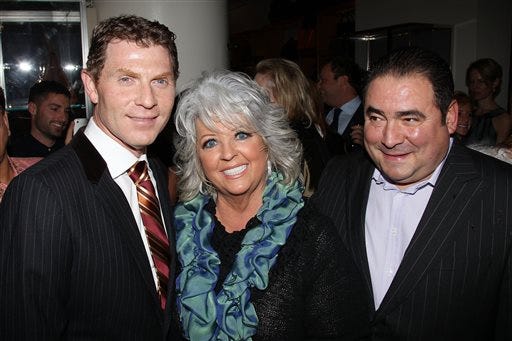FILE - In this Nov. 16, 2010 file photo provided by StarPix, from left to right, celebrity chefs Bobby Flay, Paula Deen, and Emeril Lagasse from the Food Network attend the unveiling of Barneys New York food themed holiday windows in New York. It was revealed that Deen admitted during questioning in a lawsuit that she had slurred blacks in the past. It's the second time the queen of comfort food's mouth has gotten her into big trouble. She revealed in 2012 that for three years she hid her Type 2 diabetes while continuing to cook the calorie-laden food that's bad for people like her. The Food Network, which began airing "Paula's Home Cooking" in 2002, has said it does not tolerate discrimination and is looking at the situation. (AP Photo/Marion Curtis, StarPix, file)
