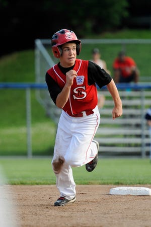 Saugus National player Ryan Groark charges toward third base to get into scoring position during the first game of the District 16 Williamsport Tournament against East Lynn at Wyoma June 25. Saugus won, 7-3.
