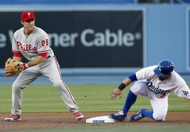 Phillies second baseman Chase Utley forces out the Dodgers' Skip Schumaker on a ball hit by Yasiel Puig in the first inning Thursday in Los Angeles. Puig was safe at first.