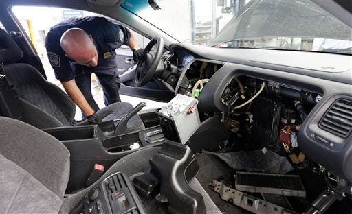 Customs and Border Protection officer Steve Delgado looks in at the dismembered dashboard of a Honda Accord after finding more than 14 pounds of methamphetamine hidden behind the radio at the San Ysidro port of entry Thursday, June 27, 2013, in San Diego.